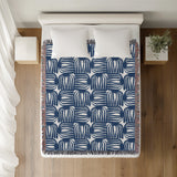 Hami Cotton Throw Blanket in Blue, on a bed