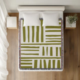 Pereto Abstract Print Cotton Throw Blanket in Chartreuse, on a bed