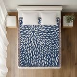 Addy Floral Cotton Throw Blanket in Blue, on a bed