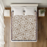 Dandelion Floral Cotton Throw Blanket in Beige, on a bed
