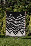 Addai Abstract Triangle Pattern Blanket Throw in Black, outdoors