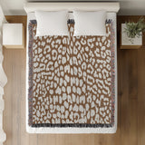Delo Animal Print Cotton Blend Blanket Throw in Rust Brown, on a bed
