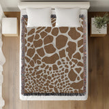 Zuma Animal Print Cotton Blend Blanket Throw in Rust Brown, on a bed