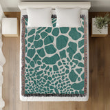 Zuma Animal Print Cotton Blend Blanket Throw in Teal, on a bed