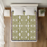 Idia Geometric Cotton Throw Blanket in Chartreuse, on a bed