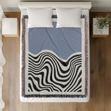 Acor Abstract Cotton Blend Blanket Throw in Blue and Off-White, on a bed