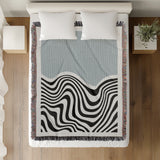 Acor Abstract Cotton Blend Blanket Throw in Gray and Off-White, on a bed