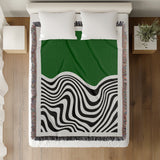 Acor Abstract Cotton Blend Blanket Throw in Green and Off-White, on a bed