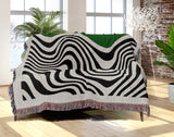 Acor Abstract Cotton Blend Blanket Throw in Green and Off-White, draped over a chair