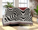 Acor Abstract Cotton Blend Blanket Throw in Red and Off-White, draped over a chair