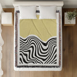 Acor Abstract Cotton Blend Blanket Throw in Yellow and Off-White, on a bed