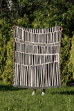 Afia Tribal Cotton Throw Blanket in Black and Beige, laid flat