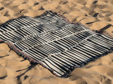 Afia Tribal Cotton Throw Blanket in Black and Beige, outdoors