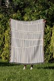 Afia Tribal Cotton Throw Blanket in Gray and Beige, laid flat