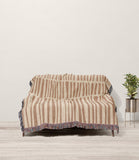 Afia Tribal Cotton Throw Blanket in Rust and Beige, draped over a sofa