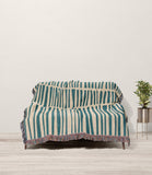 Afia Tribal Cotton Throw Blanket in Teal and Beige, draped over a sofa