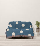 Akon Hand Woven Throw Blanket in Blue and Beige, draped over a sofa