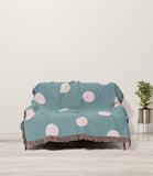 Akon Hand Woven Throw Blanket in Sky Blue and Beige, draped over a sofa