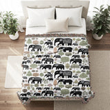 Alfie Elephant Cotton Blend Blanket Throw in Black and Off-White, on a bed