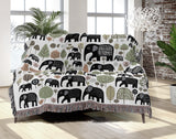 Alfie Elephant Cotton Blend Blanket Throw in Black and Off-White, draped over a chair