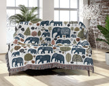 Alfie Elephant Cotton Blend Blanket Throw in Blue and Off-White, draped over a chair