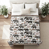 Alfie Elephant Cotton Blend Blanket Throw in Brown and Off-White, on a bed