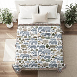 Alfie Elephant Cotton Blend Blanket Throw in Light Blue and Off-White, on a bed