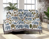 Alfie Elephant Cotton Blend Blanket Throw in Light Blue and Off-White, draped over a chair