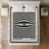 Bauhaus Eye Abstract Cotton Blend Blanket Throw in Blue, Black and Off-White, on a bed
