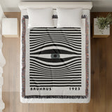 Bauhaus Eye Abstract Cotton Blend Blanket Throw in Gray, Black and Off-White, on a bed