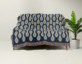 Alo Cotton Blend Blanket Throw in Blue, draped over a chair