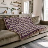 Alo Cotton Blend Blanket Throw in Purple, draped over a chair