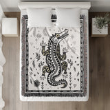 Amiro Crocodile Cotton Blend Blanket Throw in Black and Off-White, on a bed