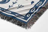 Amiro Crocodile Cotton Blend Blanket Throw in Blue and Off-White, draped over a chair