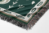 Amiro Crocodile Cotton Blend Blanket Throw in Emerald and Off-White, draped over a chair