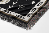 Amiro Crocodile Cotton Blend Blanket Throw in Off-White, draped over a chair
