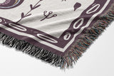 Amiro Crocodile Cotton Blend Blanket Throw in Purple and Off-White, draped over a chair