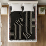 Askii Cotton Blend Blanket Throw in Black, on a bed