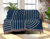 Askii Cotton Blend Blanket Throw in Navy Blue, draped over a chair