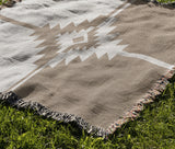 Asko Southwestern Cotton Blend Blanket Throw in Beige and Off-White, draped over a chair
