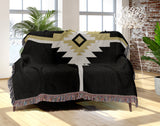 Asko Southwestern Cotton Blend Blanket Throw in Black, Off-White and Dull Gold, draped over a chair