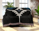 Asko Southwestern Cotton Blend Blanket Throw in Blue, Black and Off-White, draped over a chair