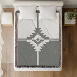 Asko Southwestern Cotton Blend Blanket Throw in Gray and Off-White, on a bed