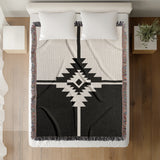 Asko Southwestern Cotton Blend Blanket Throw in Black and Off-White, on a bed