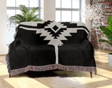 Asko Southwestern Cotton Blend Blanket Throw in Black and Off-White, draped over a chair