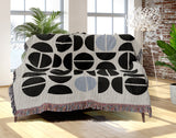 Barro Abstract Cotton Blend Blanket Throw in Blue, Black and Off-White, draped over a chair