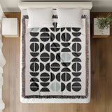 Barro Abstract Cotton Blend Blanket Throw in Gray, Black and Off-White, on a bed