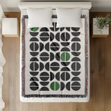 Barro Abstract Cotton Blend Blanket Throw in Green, Black and Off-White, on a bed