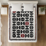 Barro Abstract Cotton Blend Blanket Throw in Red, Black and Off-White, on a bed