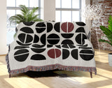 Barro Abstract Cotton Blend Blanket Throw in Red, Black and Off-White, draped over a chair